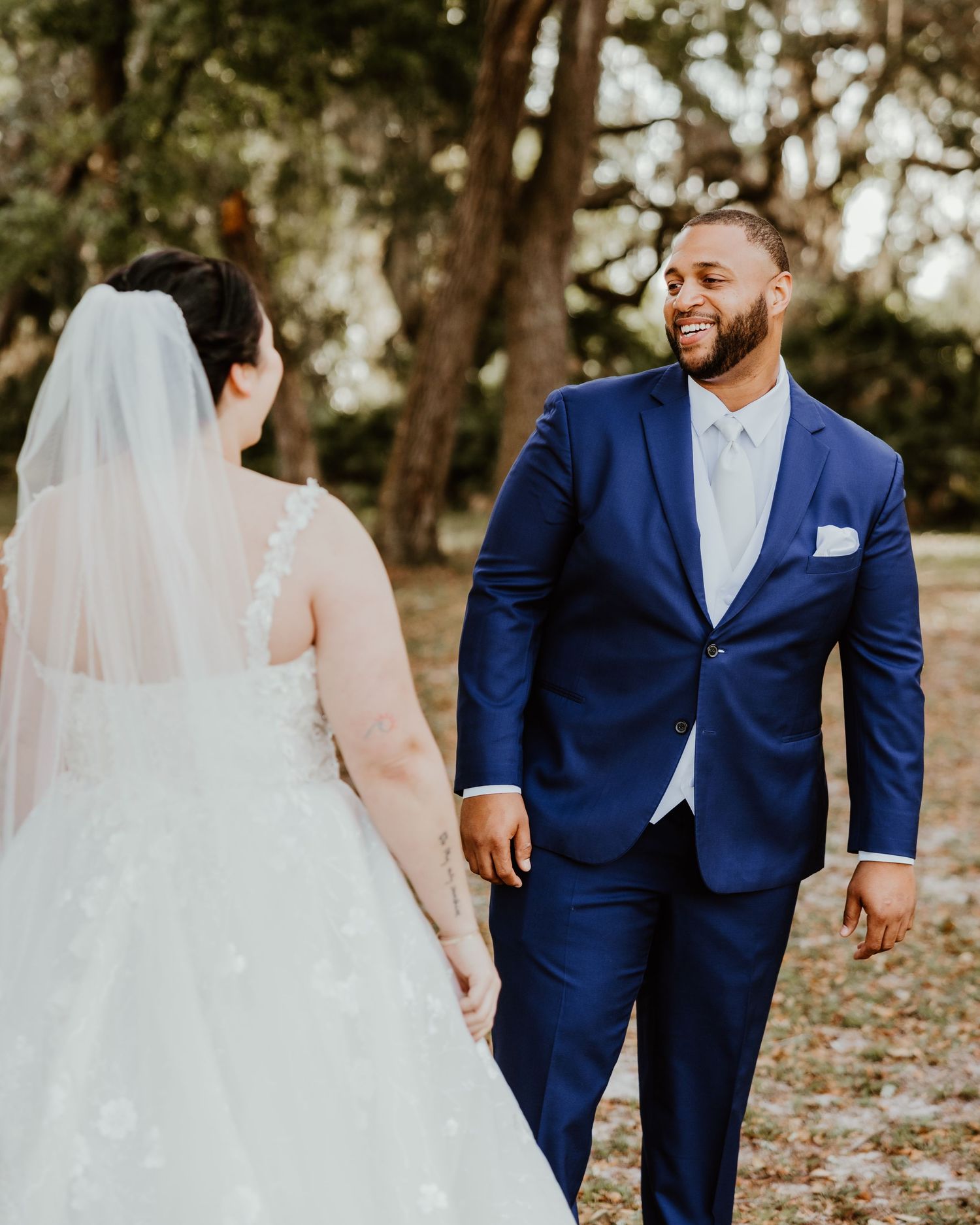 Fall wedding portrait sequence with couple in navy suit and white ballgown outdoors.