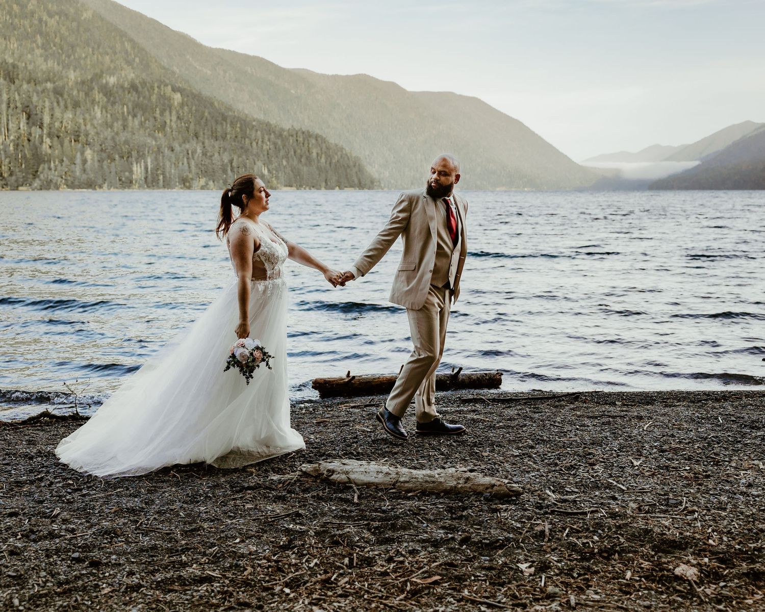 A series of romantic lakeside wedding photos showing a couple walking along a rocky shore with mountains in the background. Editorial photo