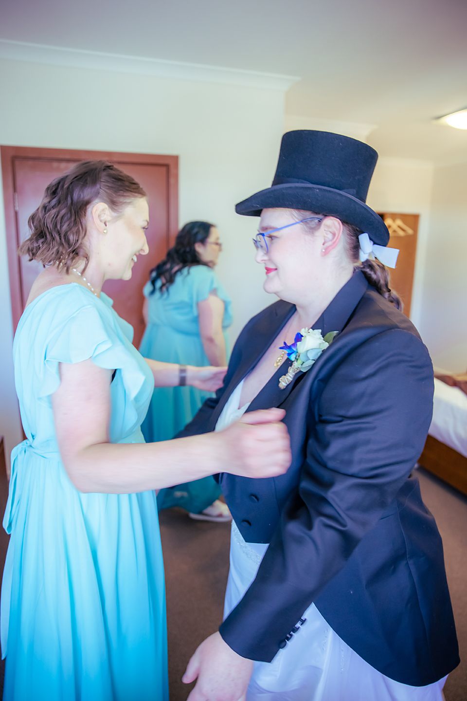 A series of candid reception photos showing people dancing together in formal attire including blue dresses and dark suits.