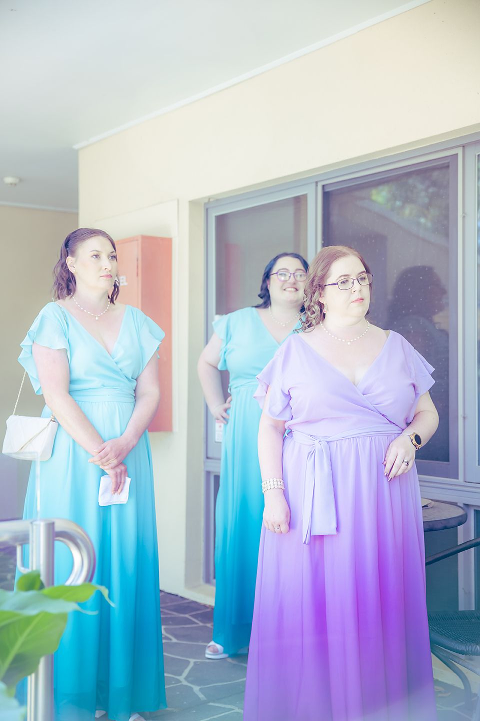 Side by side photo series showing two bridesmaid dresses in turquoise blue and lavender purple being modeled on a patio.