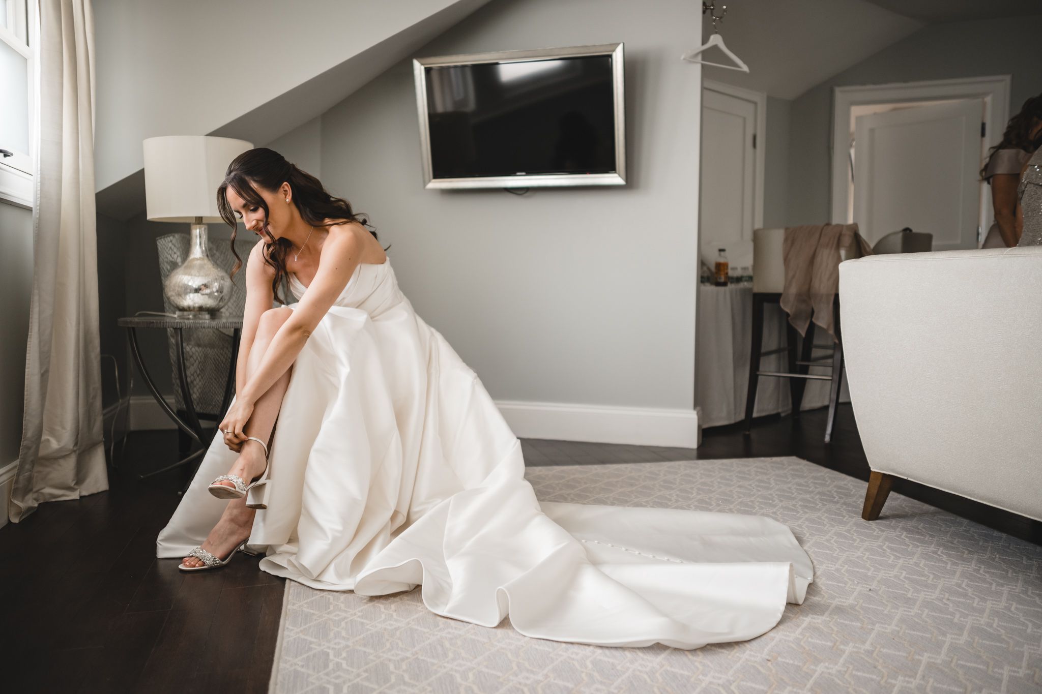 Wedding party gathered in a modern room with natural lighting.