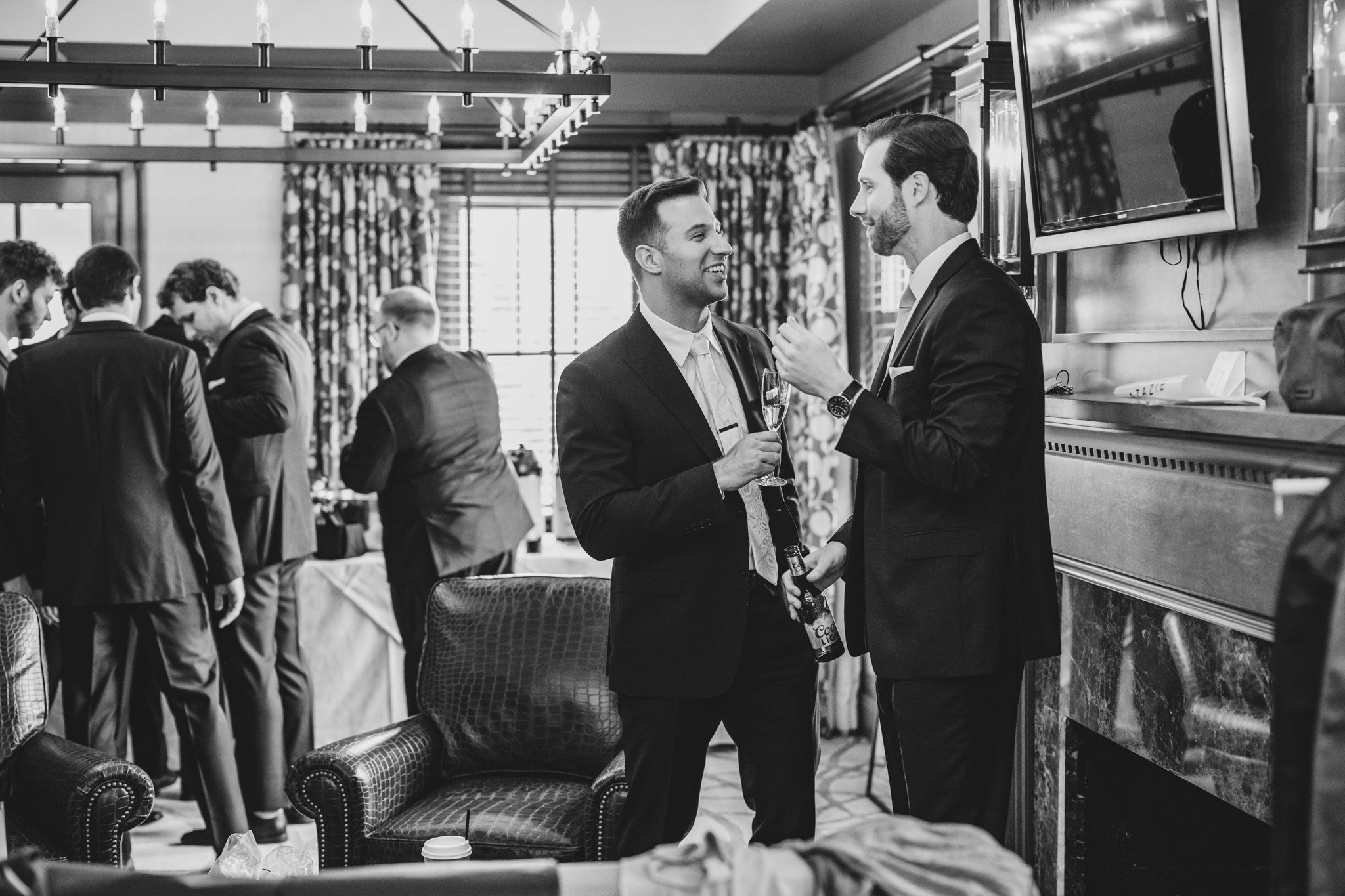 Black and white images capture pre-wedding preparations and candid moments among groomsmen.