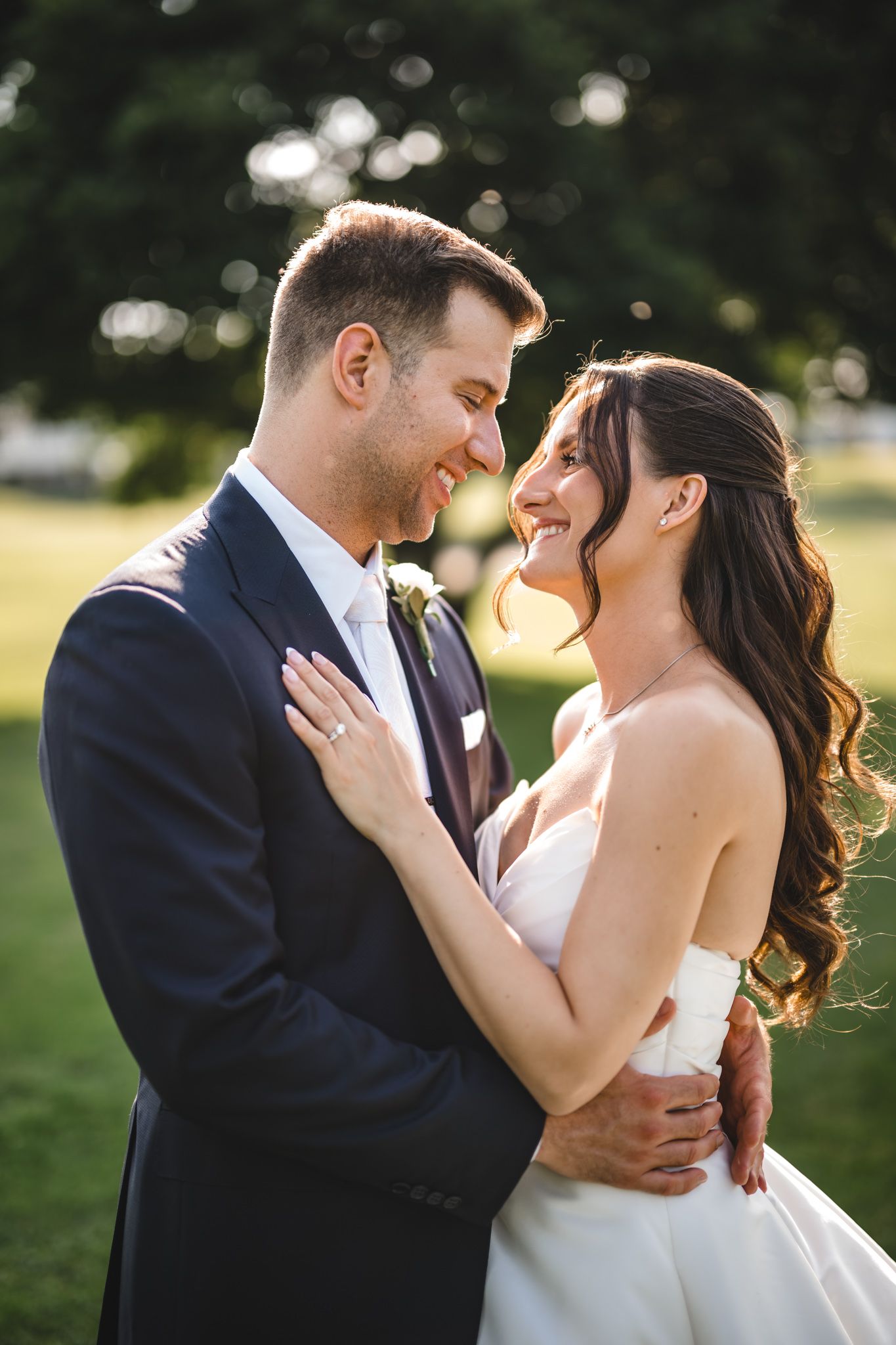 Intimate wedding portraits captured in a lush garden setting during sunset.