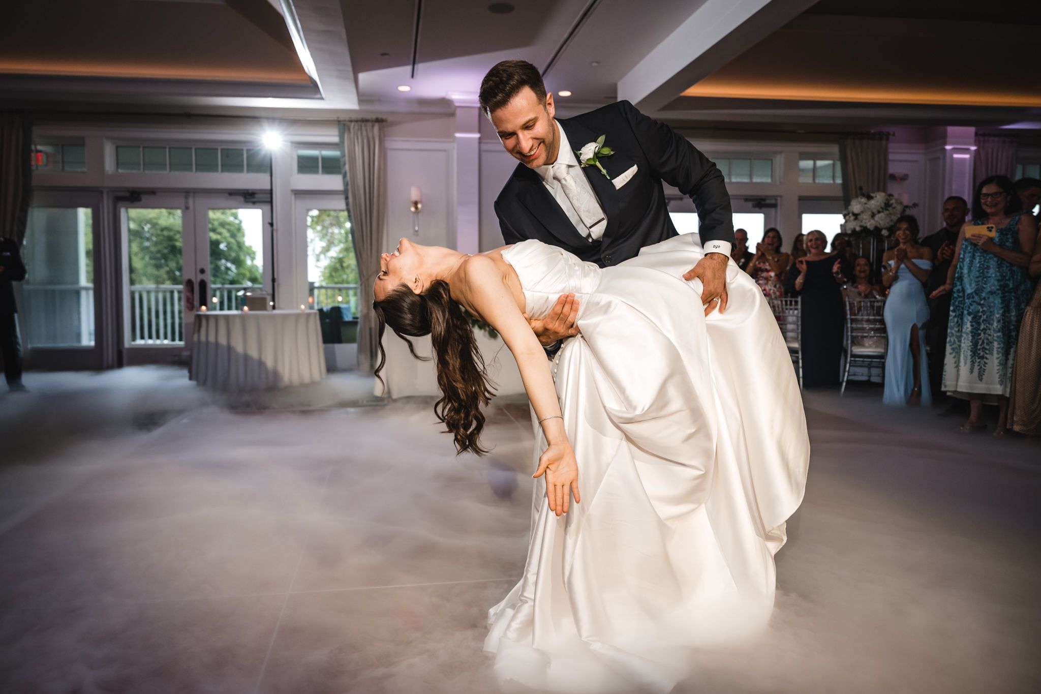 Dramatic dance sequence captured in dark venue with theatrical lighting and smoke effects.
