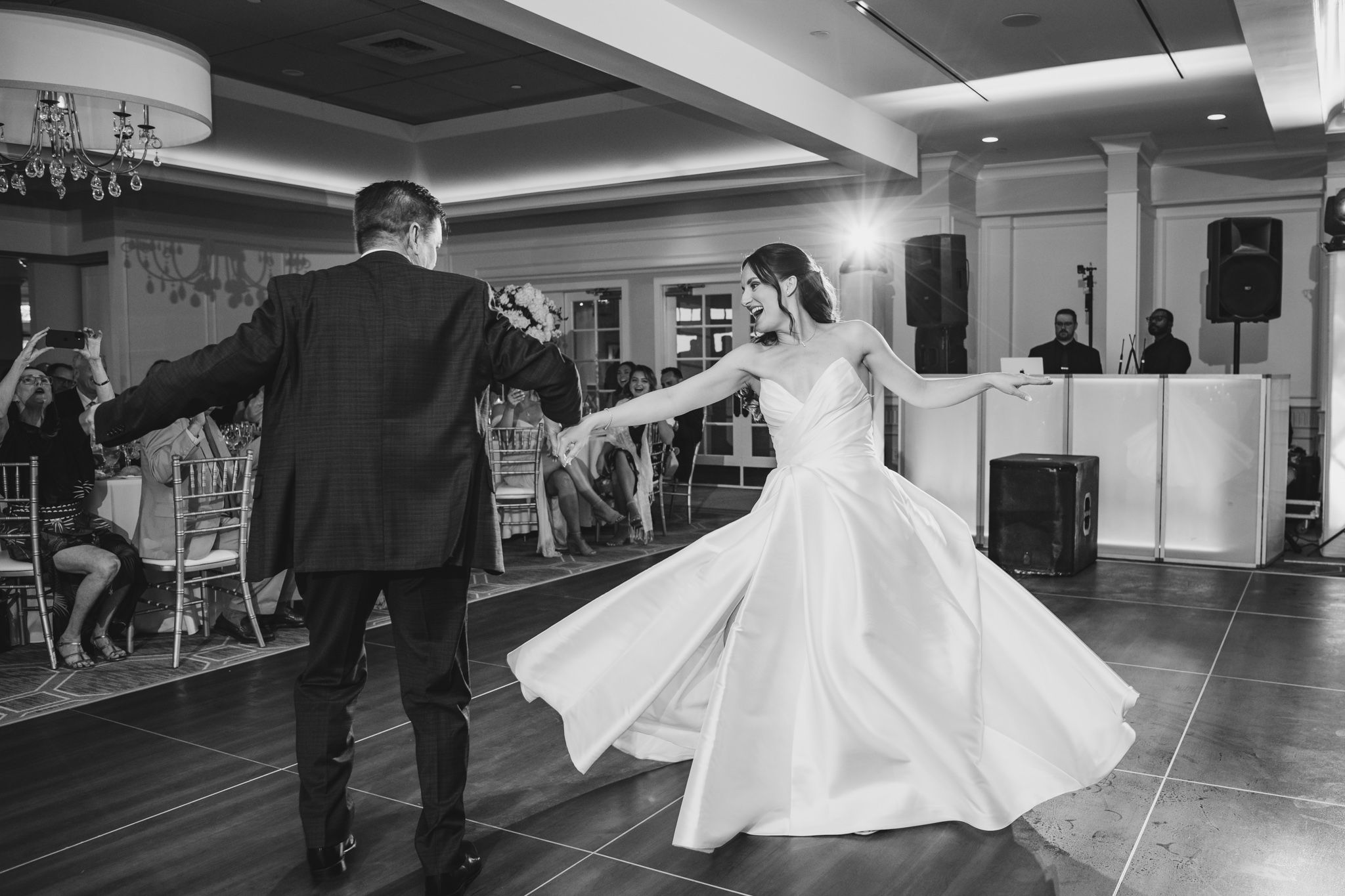 Wide-angle shot of ballroom dance performance with atmospheric lighting and fog effects.