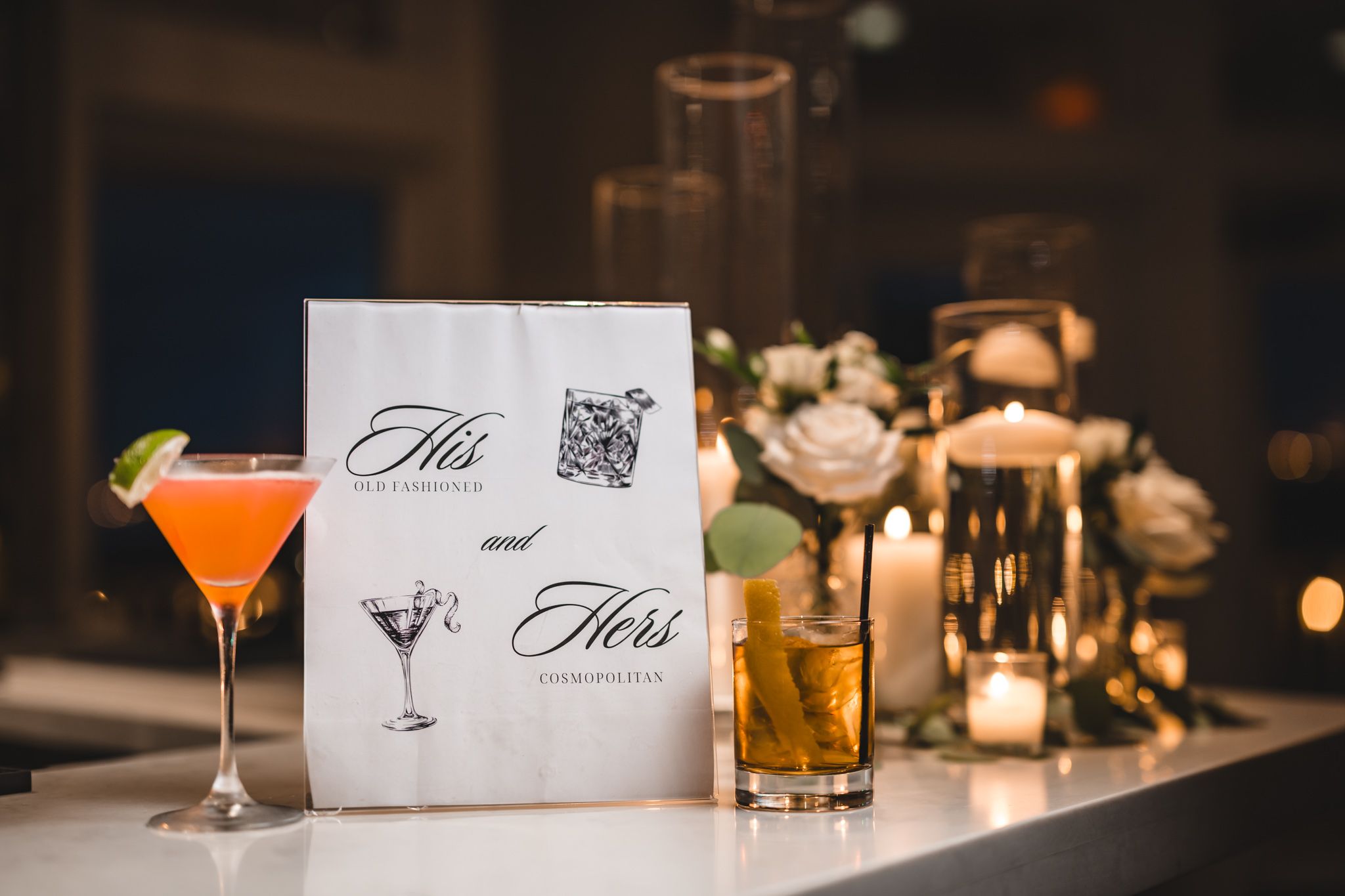 Elegant cocktails and drinks displayed at a wedding reception bar.