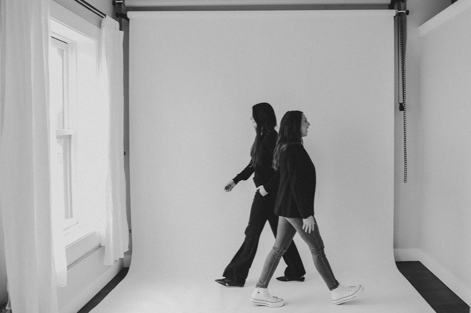 Minimalist black and white dance photography in an empty white studio.