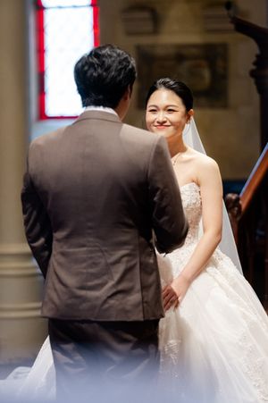 An intimate wedding ceremony moment in a traditional church setting.