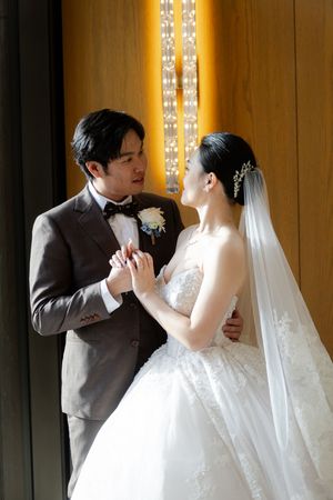 Sequence of elegant wedding dance poses in a warmly lit venue with decorative lighting panels.