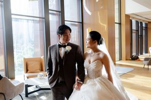 Modern wedding venue interior with floor-to-ceiling windows and natural lighting.