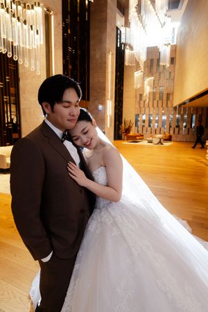 Intimate wedding portraits taken in a luxurious venue with golden lighting and elegant decor.