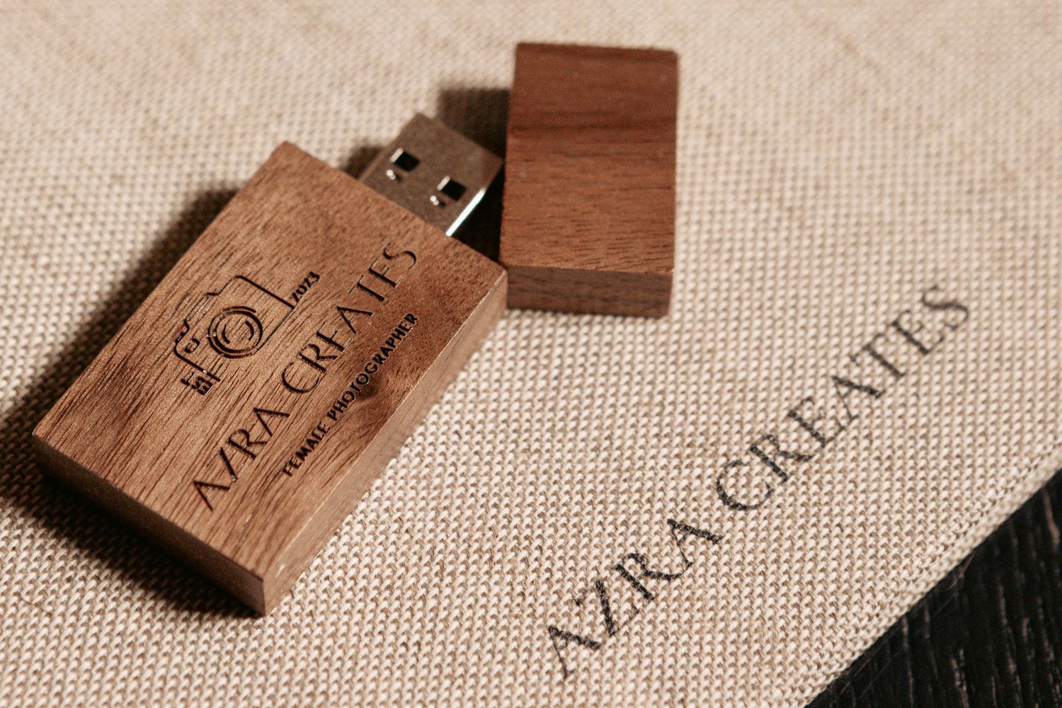 Collection of wooden wine corks arranged on neutral fabric background.