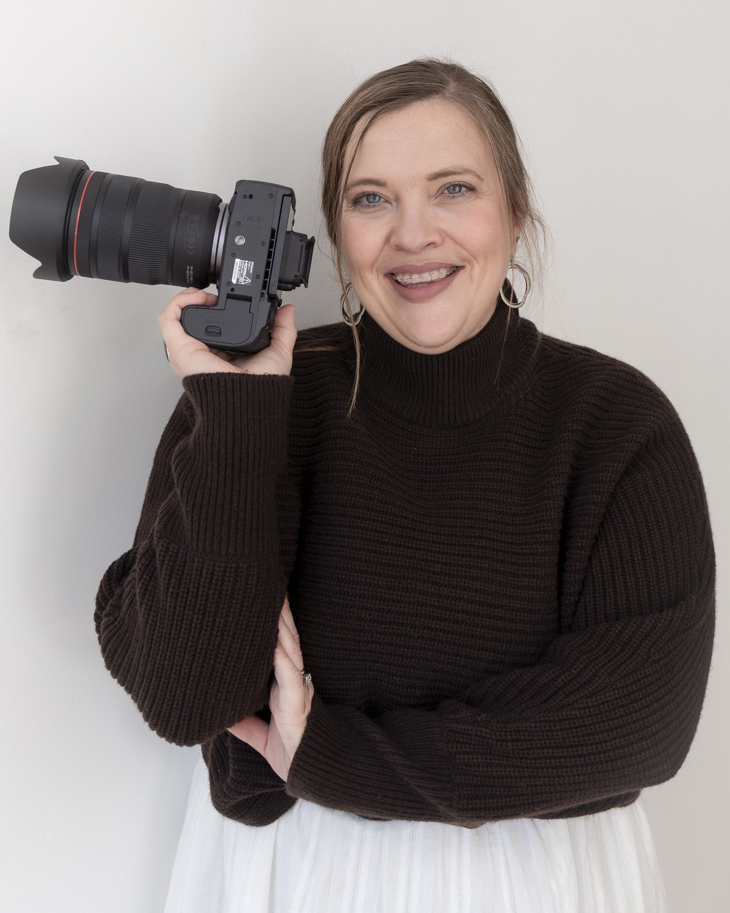 Smiling woman in a black hat and blazer professional headshot for Ogden, Utah portrait, family real estate photographer.
