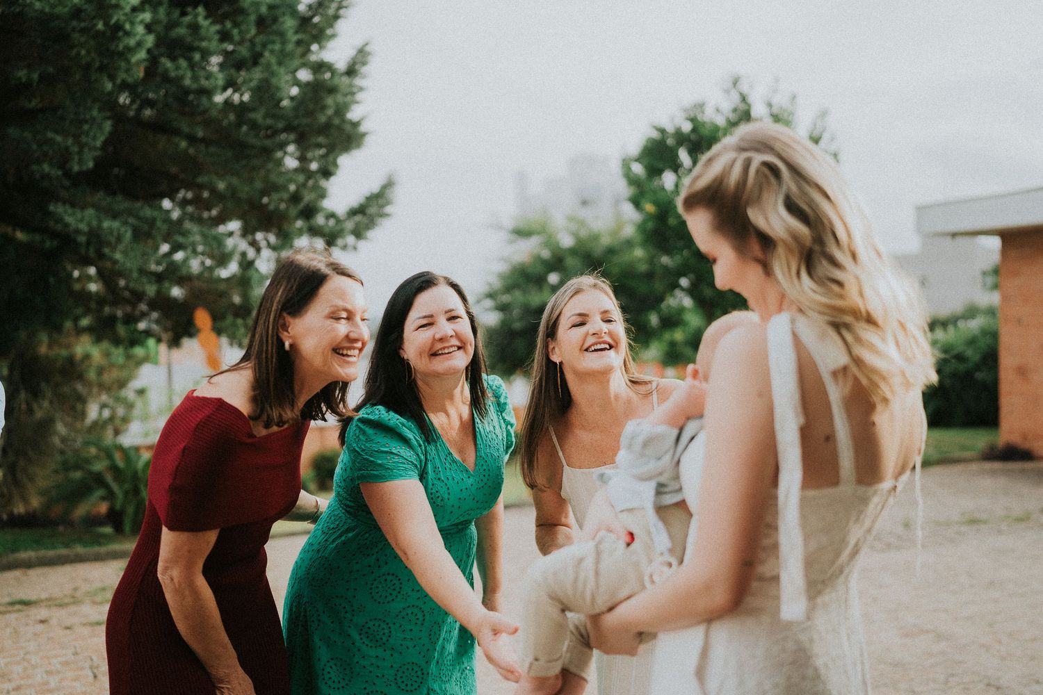 A group of friends sharing laughter and joy at an outdoor celebration.