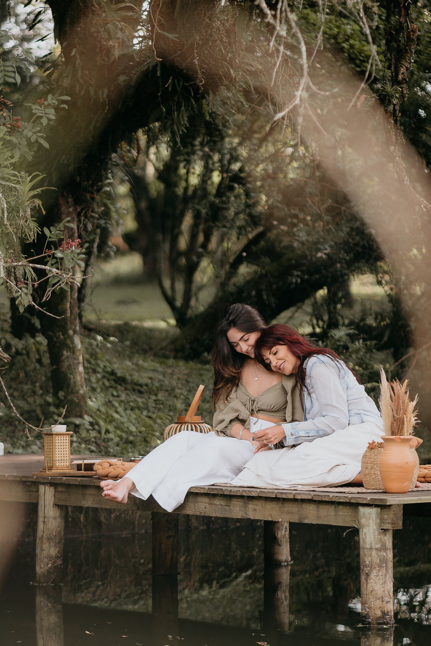 Person resting on a rustic wooden bench in a dreamy outdoor setting.