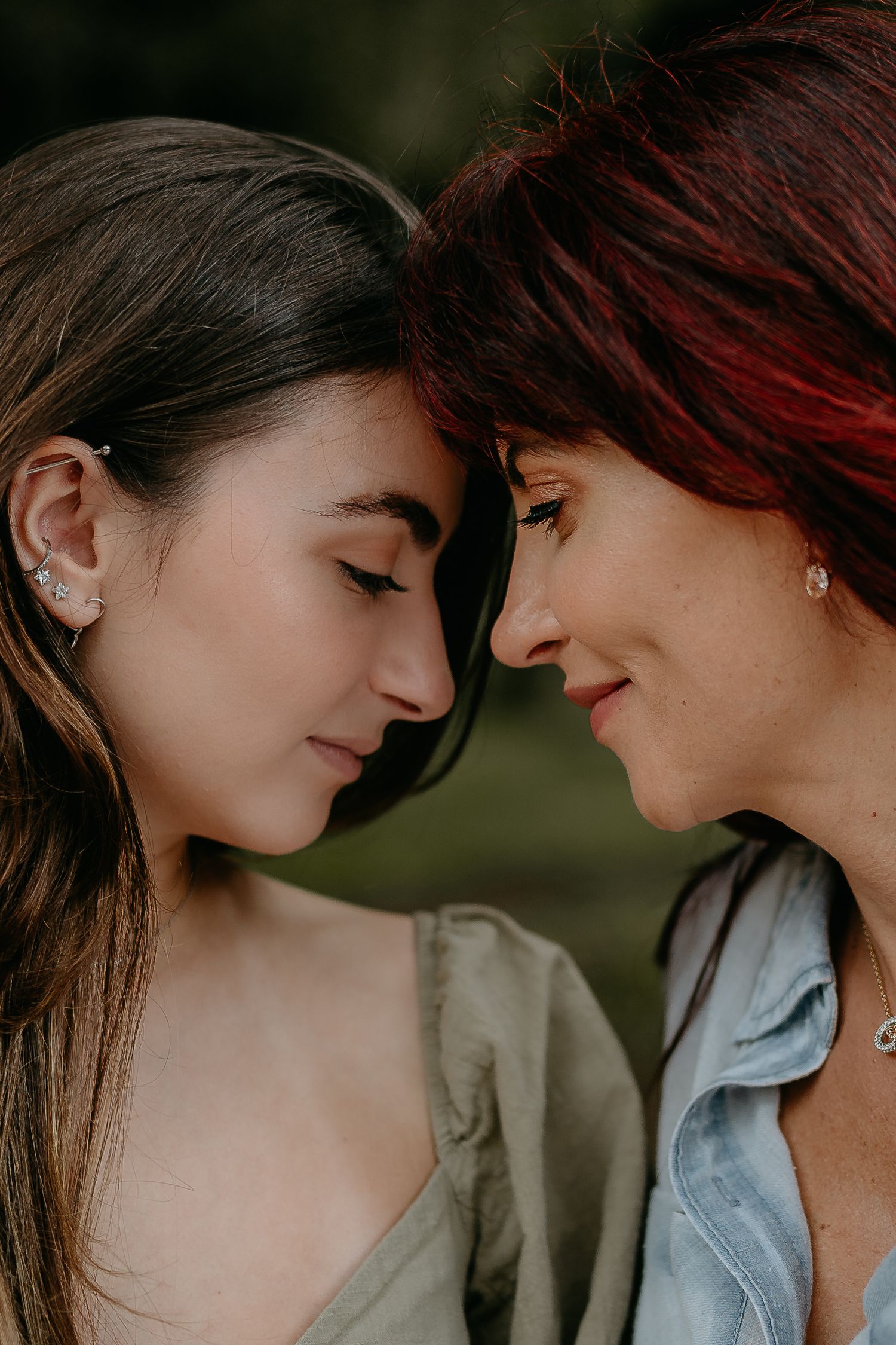 Close-up shot of two people sharing an intimate moment against a dark background.
