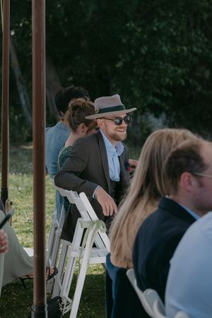 Guests mingling under outdoor canopies at an elegant outdoor gathering.