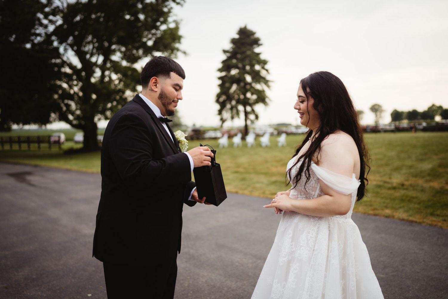 Bride and groom share candid laughter and joyful moments together during outdoor wedding photoshoot.