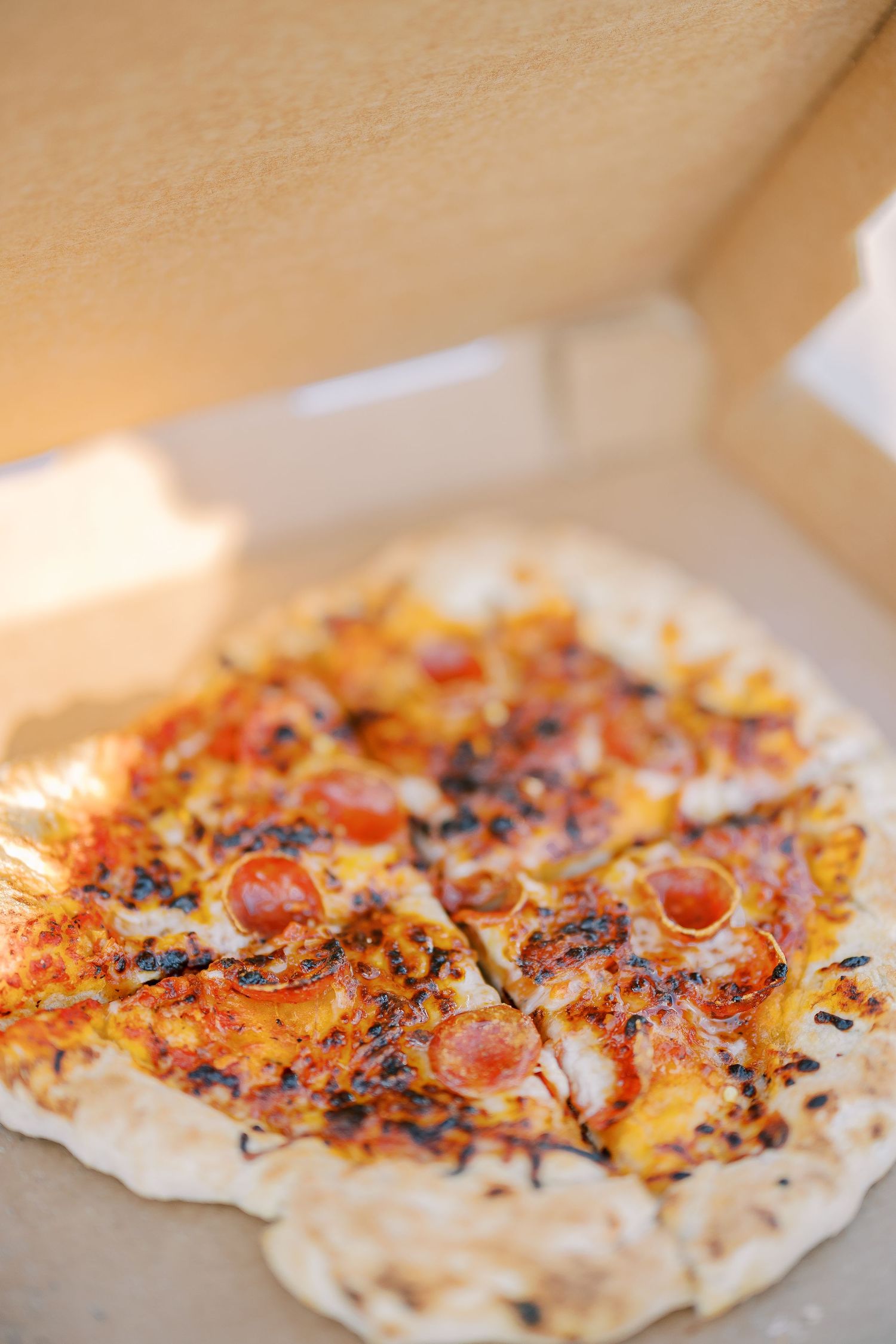 Grilled flatbread with charred toppings and red sauce appearing in sequential close-up shots.