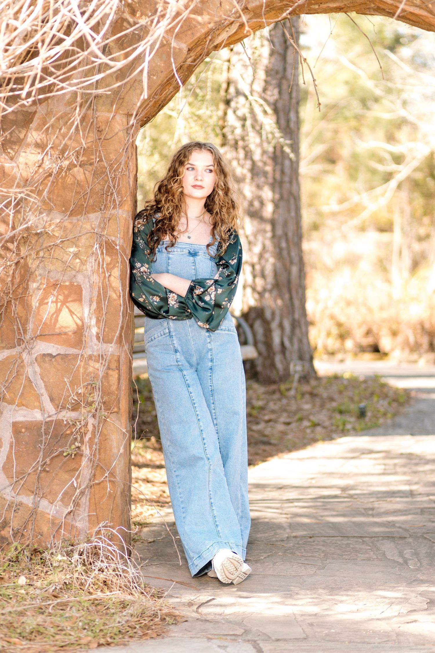 A series of outdoor portrait photos featuring someone in denim against a nature backdrop with tree trunks and branches.