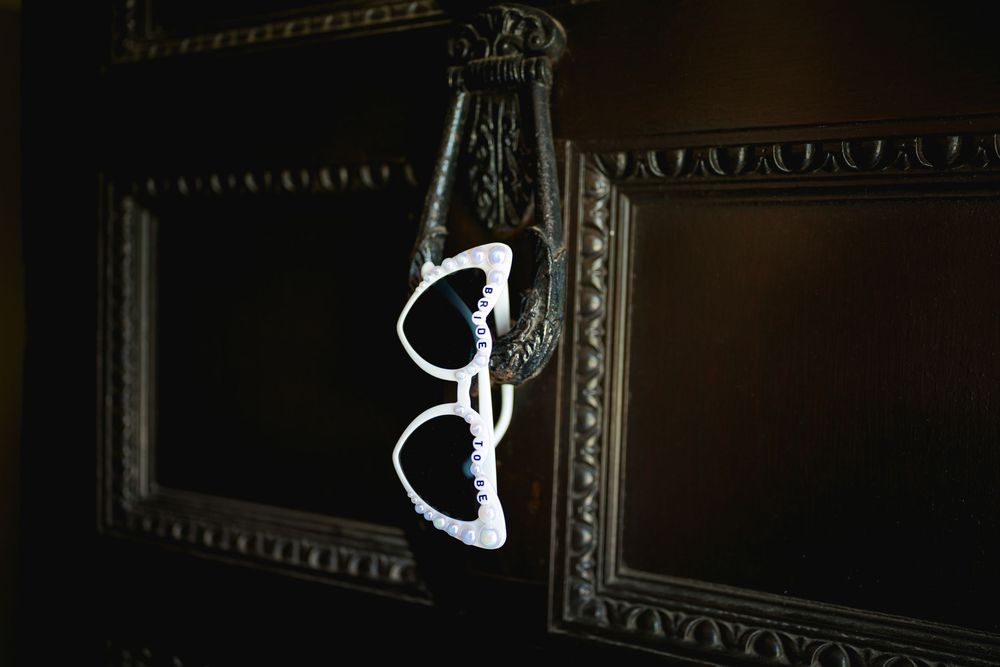 Artistic silhouette photography through vintage frames creating dramatic wedding day compositions.