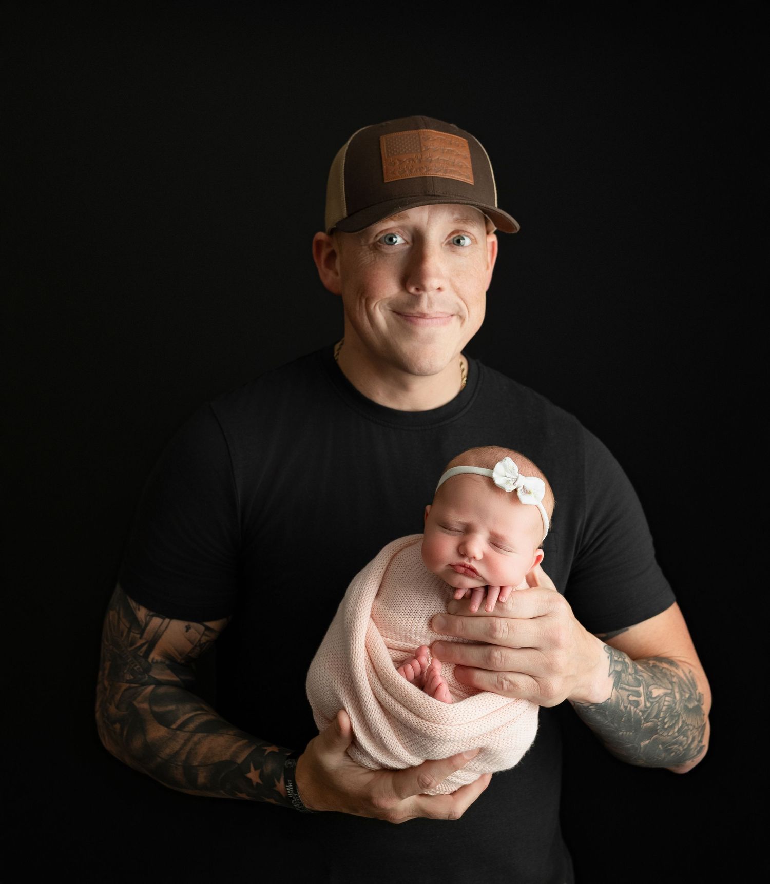 Dad is holding the newborn baby girl very tenderly. - Greenville SC newborn photographer - Easley SC newborn photographer