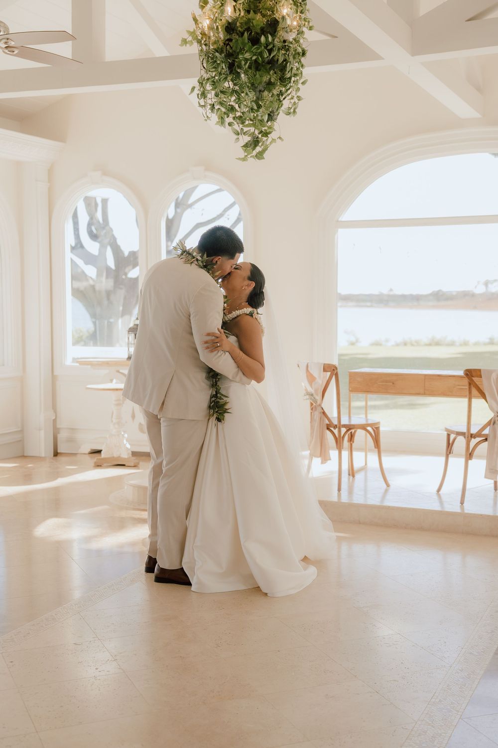 A series of romantic wedding photos showing tender moments between a couple in a bright indoor venue with hanging plants.