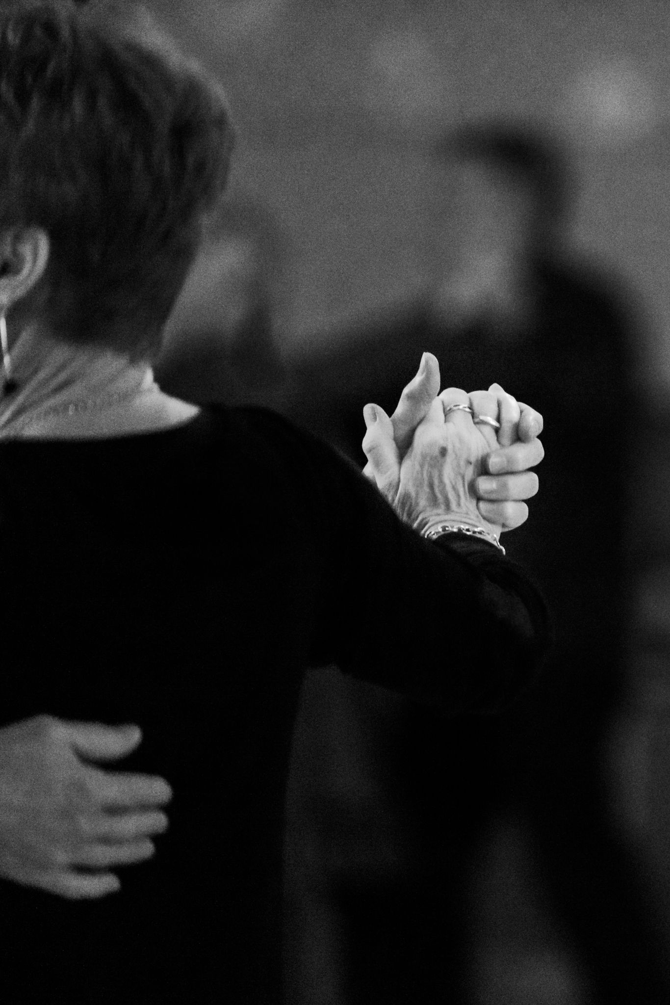Black and white image of the hands of a couple dancing. Event photographer in Newbridge, South Wales