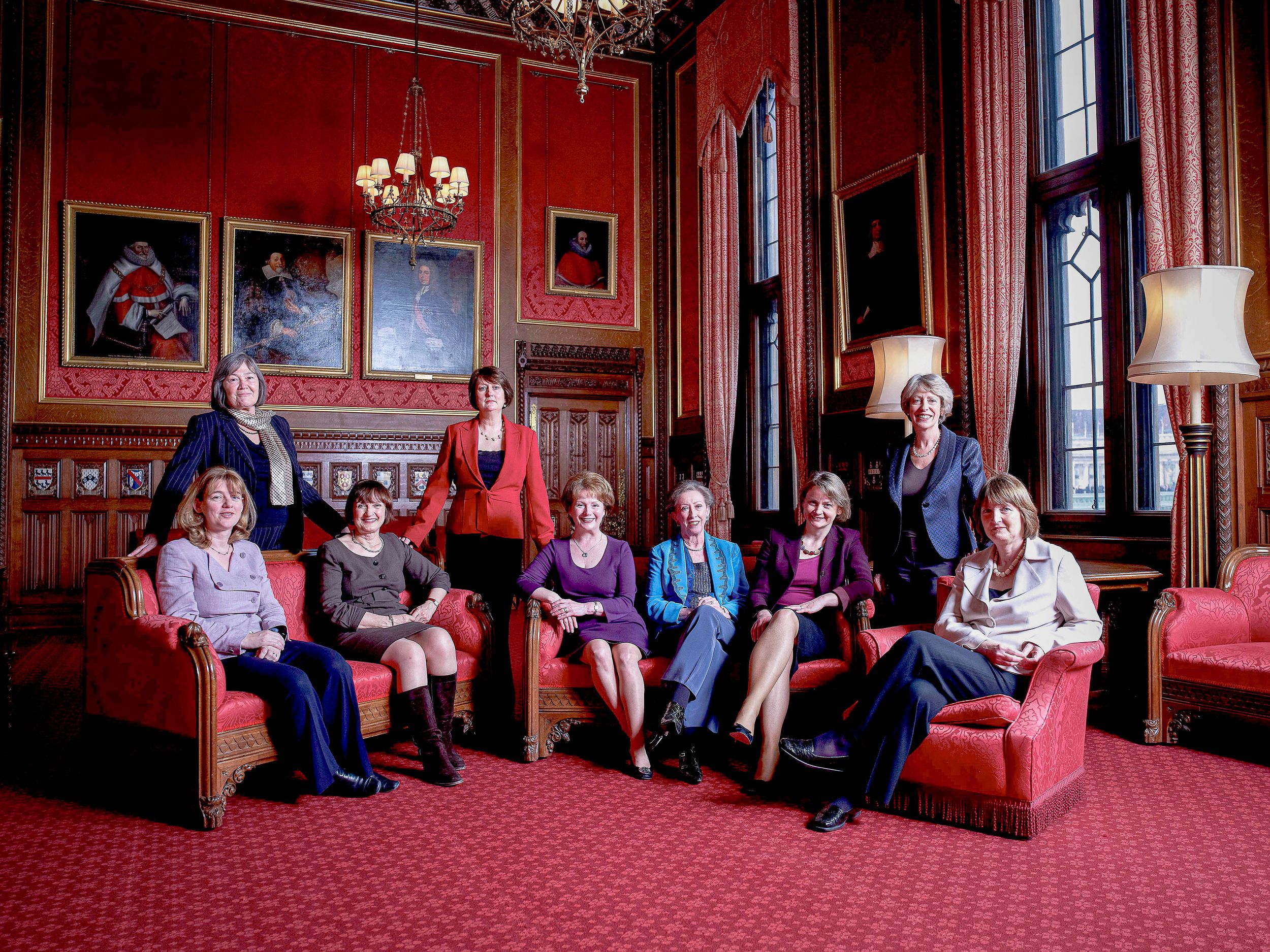 Labour Party female Minister seated in an ornate red room with elegant decor, chandeliers and traditional furnishings.