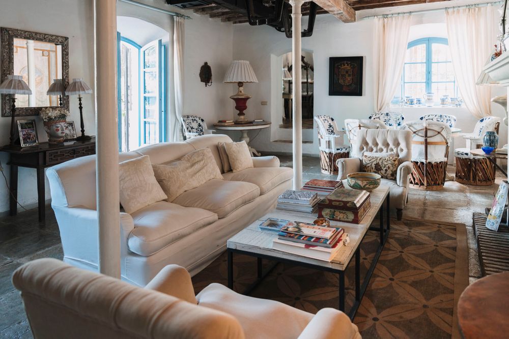 Elegant living room with comfortable beige sofas and traditional Mediterranean decor.