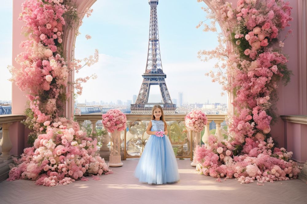 Valentine's day themed photo session of a romantic balcony scene with pink floral arch and a girl against Eiffel Tower backdrop in Paris.