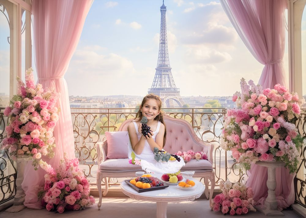 Valentine's day themed photo session of a romantic balcony scene with pink floral arch and a girl against Eiffel Tower backdrop in Paris.