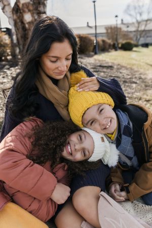 A heartwarming embrace shared on a sunny winter day outdoors.