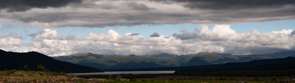 New Zealand landscape; lake, mountains, sky with billowy clouds; image by mark swanson photography