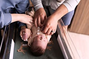 Candid hospital photos capturing early moments with a newborn baby.