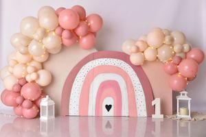 Elegant pink and peach balloon garland with white number one decorations.