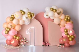 Soft pink and gold balloon garland with delicate number one decoration.