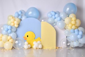 Baby shower backdrop with rubber duck theme featuring blue and yellow balloon arch.