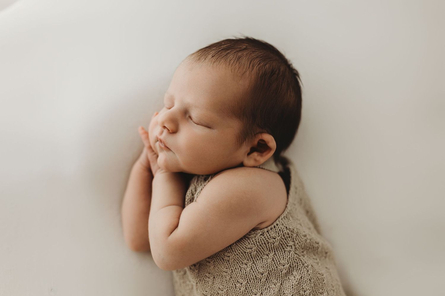 No face photography, neutral tones photographer, macro photography, baby posed naturally,