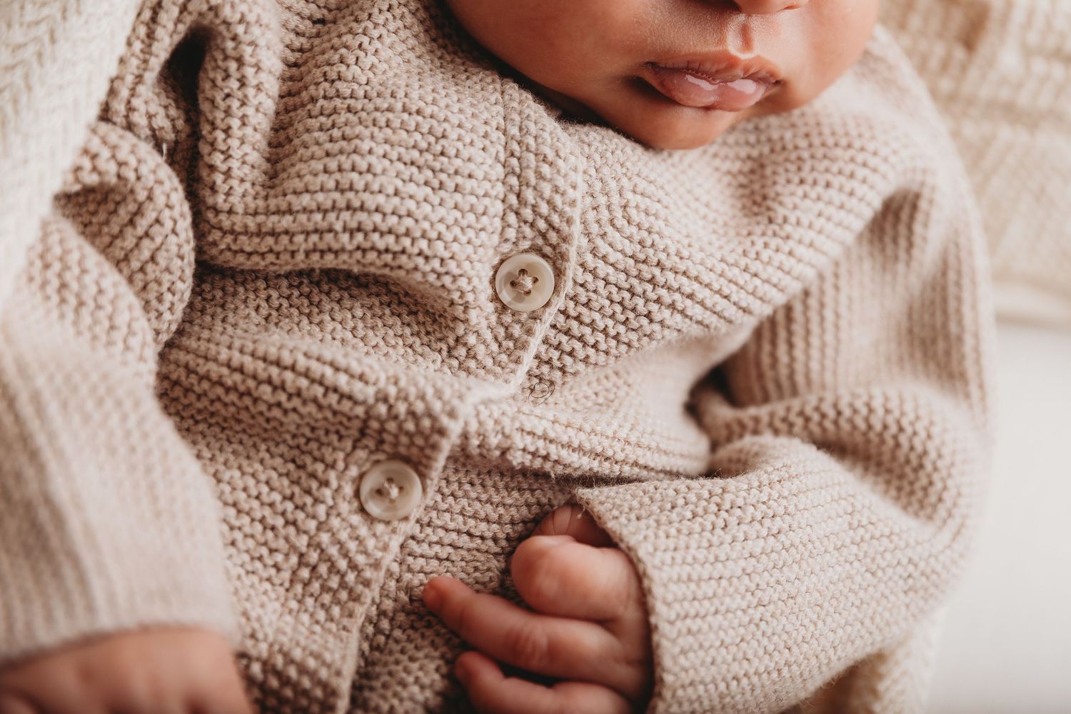 No face photography, neutral tones photographer, macro photography, baby posed naturally,