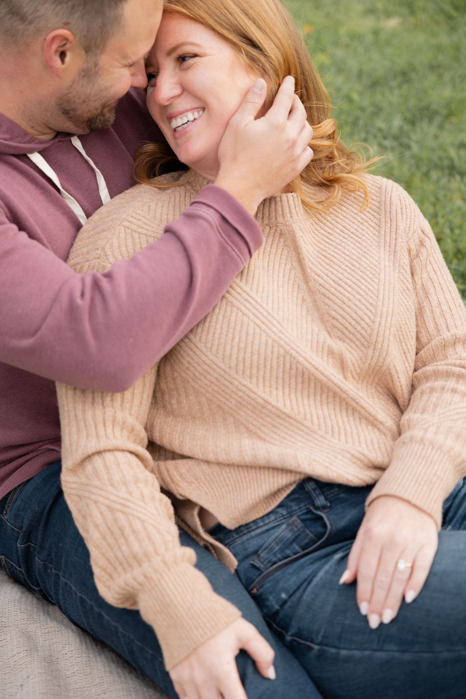 An intimate moment between a couple wearing cozy sweaters outdoors.