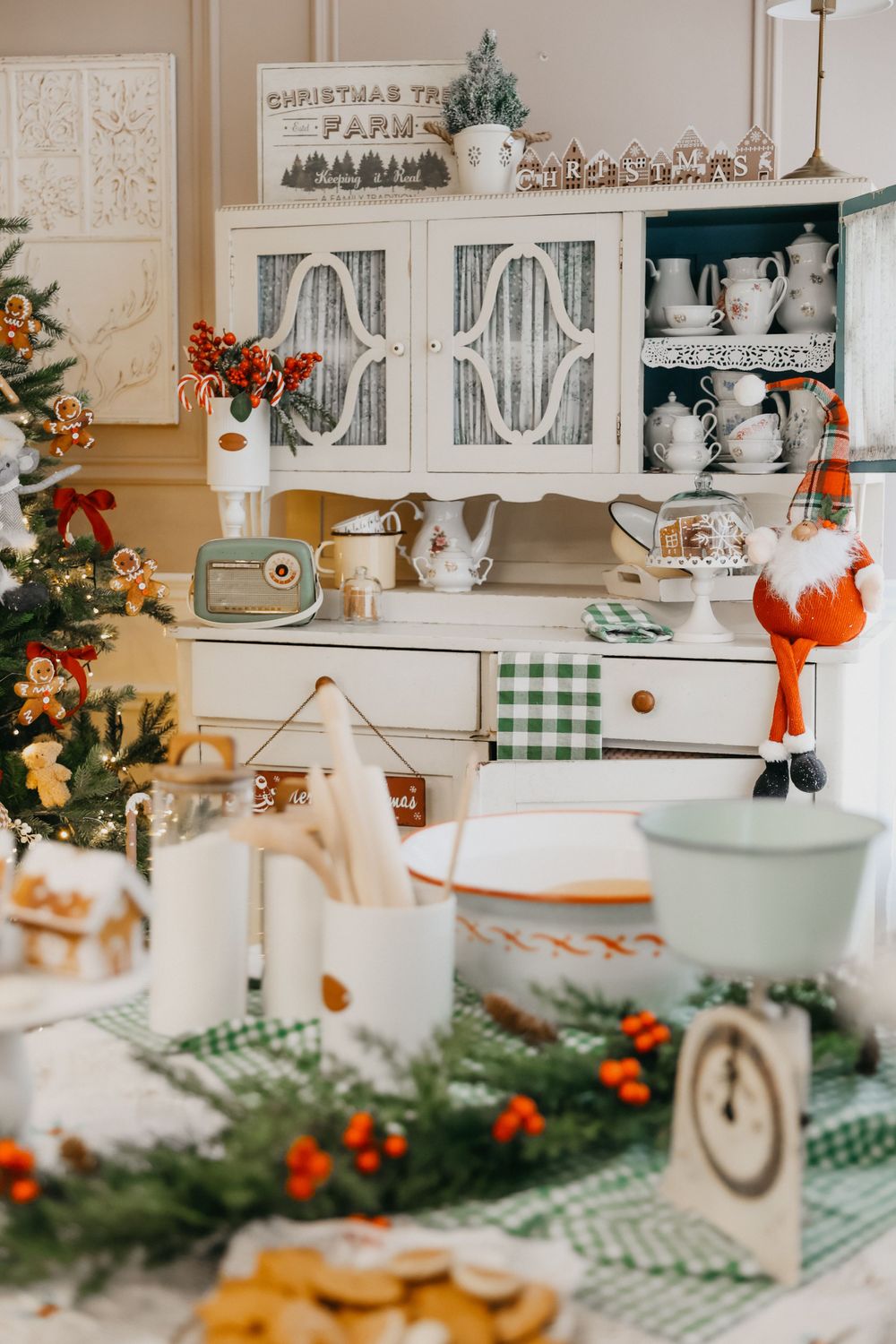 Vintage-style kitchen decorated for Christmas with green checkered accents and festive ornaments.