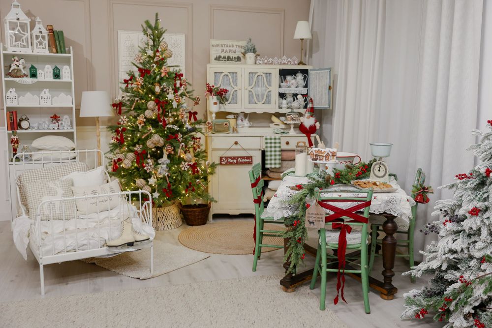 Vintage-style holiday room with white furniture, multiple Christmas trees, and a charming dining area.