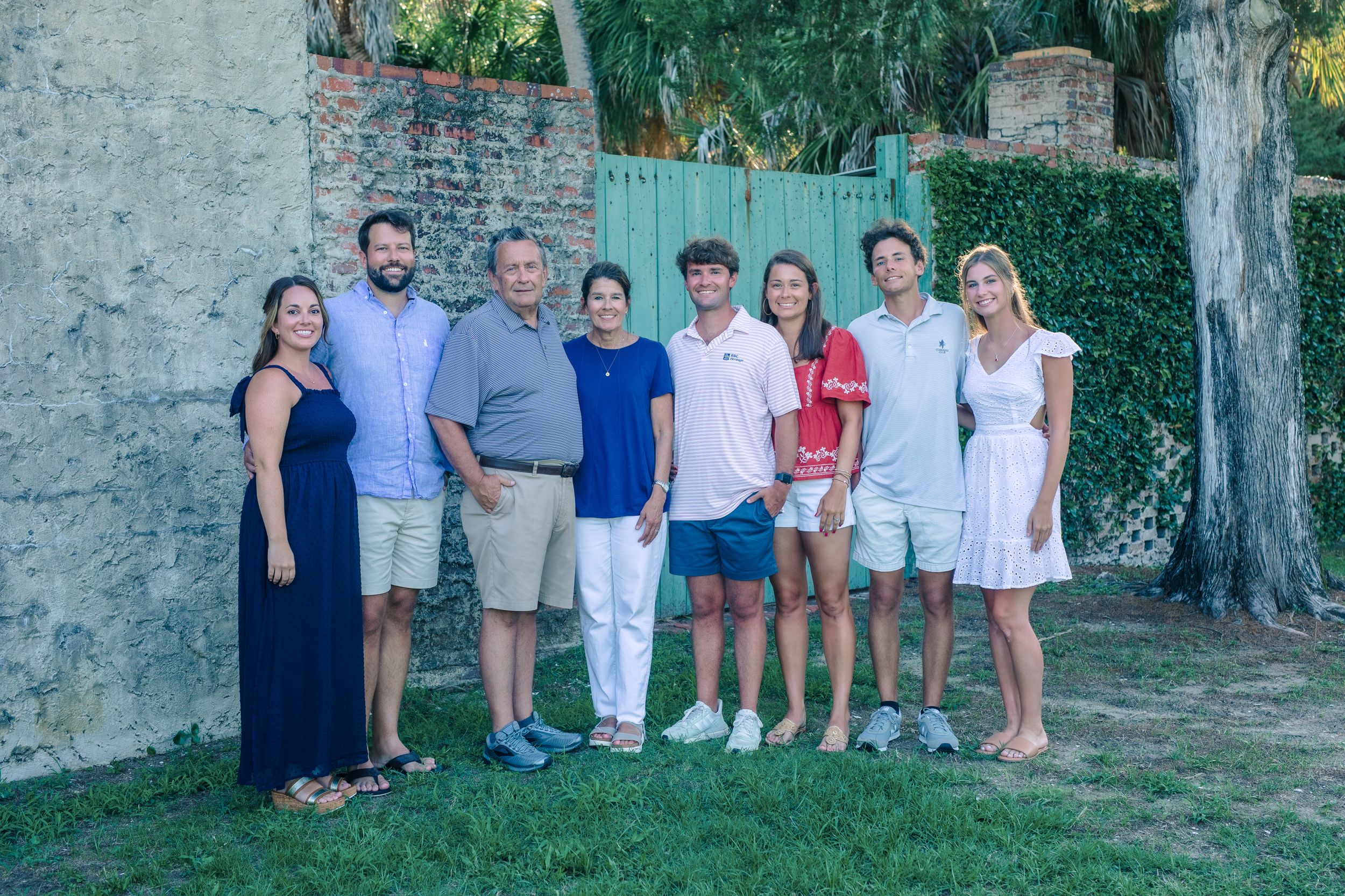Happy family portrait on vacation, smiling together outdoors, Windsor Ontario park.