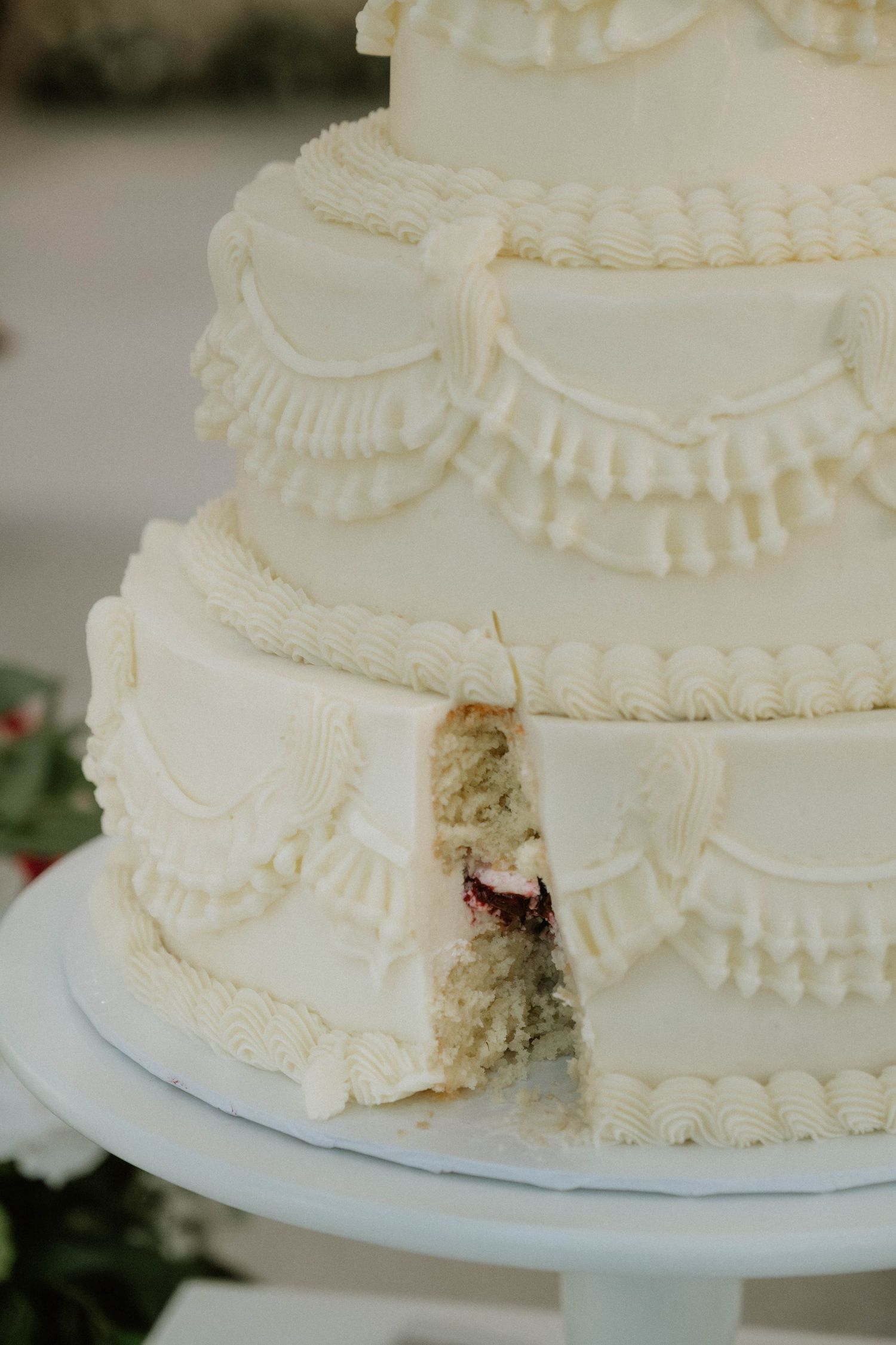 Close-up of white decorative frosting details on a wedding cake.