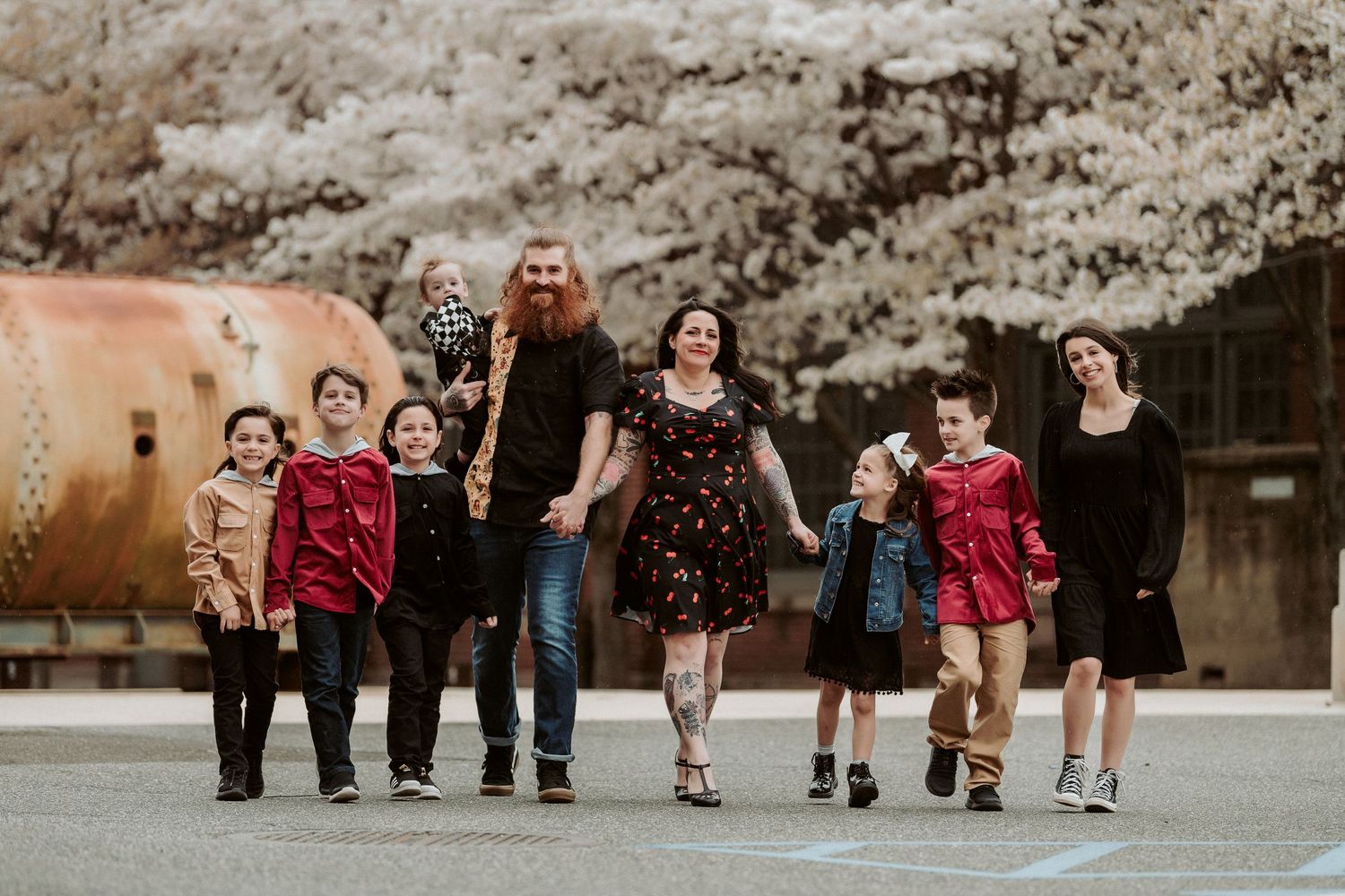 A joyful outdoor family moment captured during golden hour in an autumn setting.