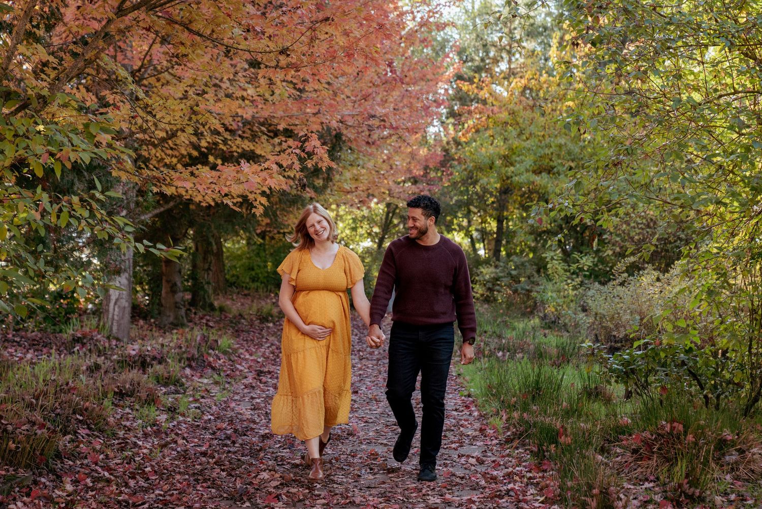 Expecting couple walking in autumn foliage, Portland Oregon maternity session in the Pacific Northwest.