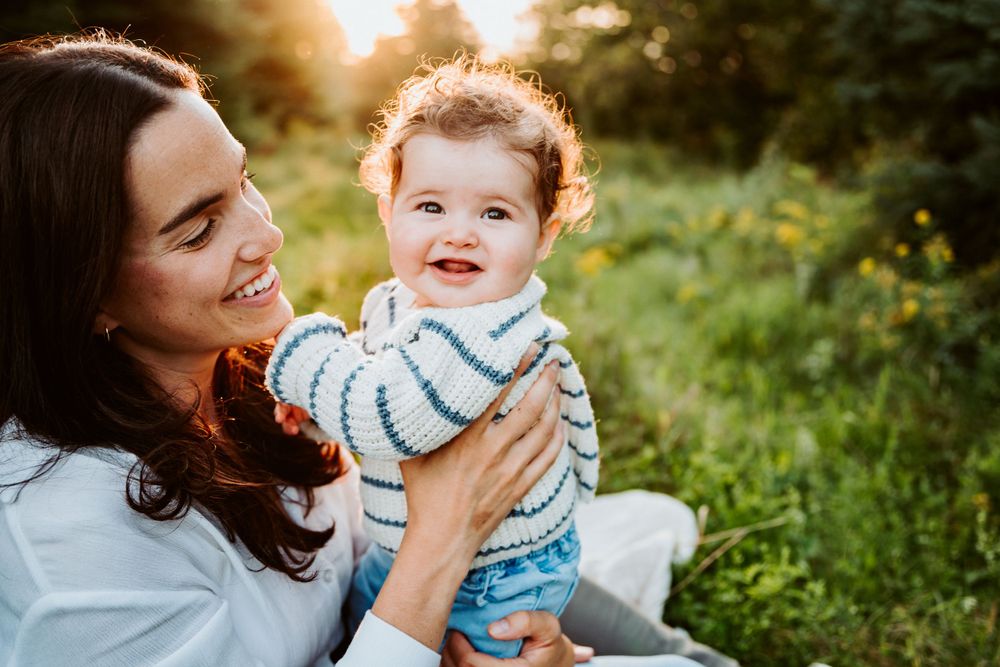 Joyful moment shared between parent and child outdoors in natural setting.