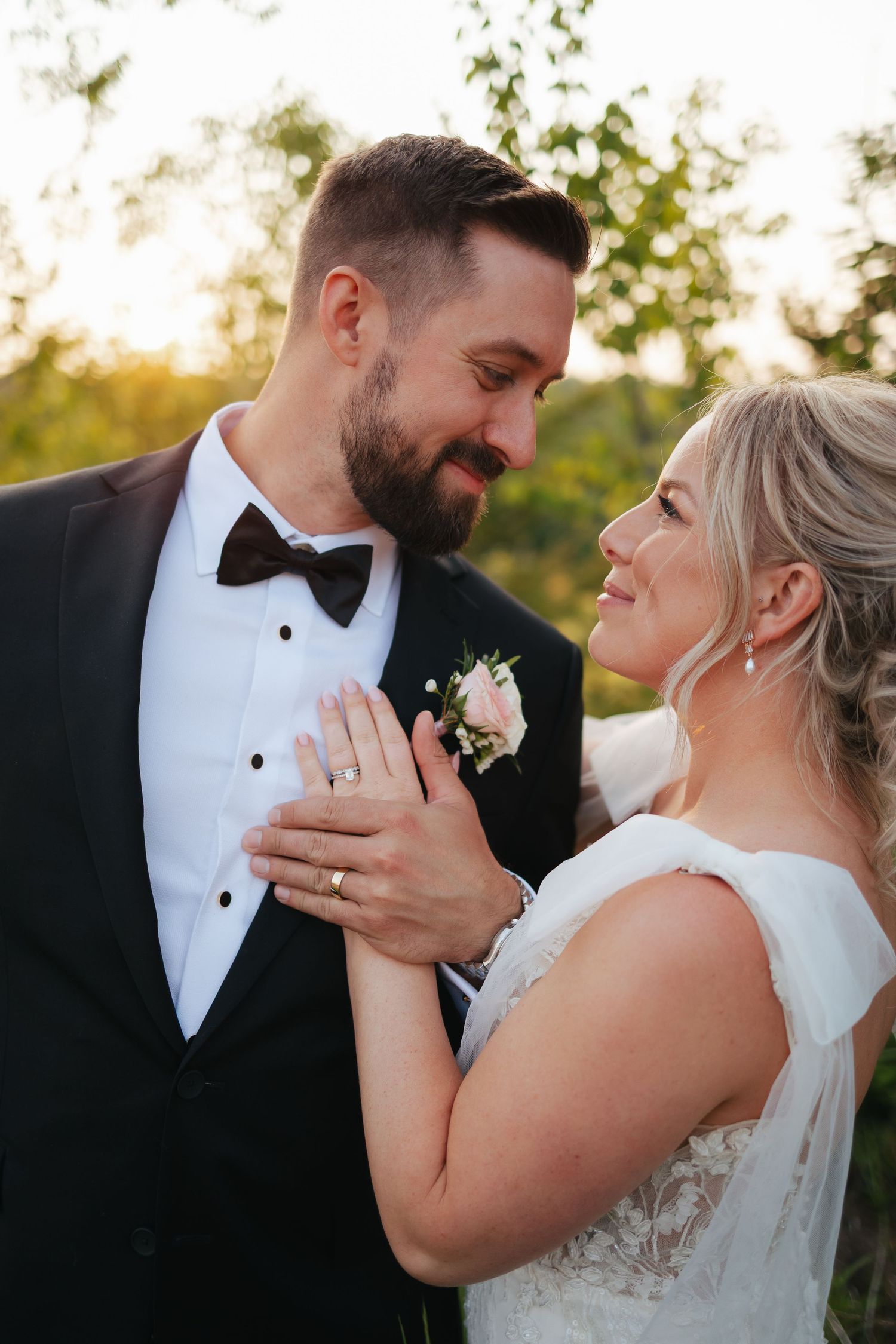 Romantic outdoor wedding portrait during golden hour sunset.