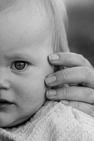 Artistic black and white close-up detail of a baby's features.